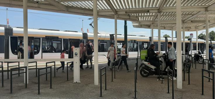 People in front of tram